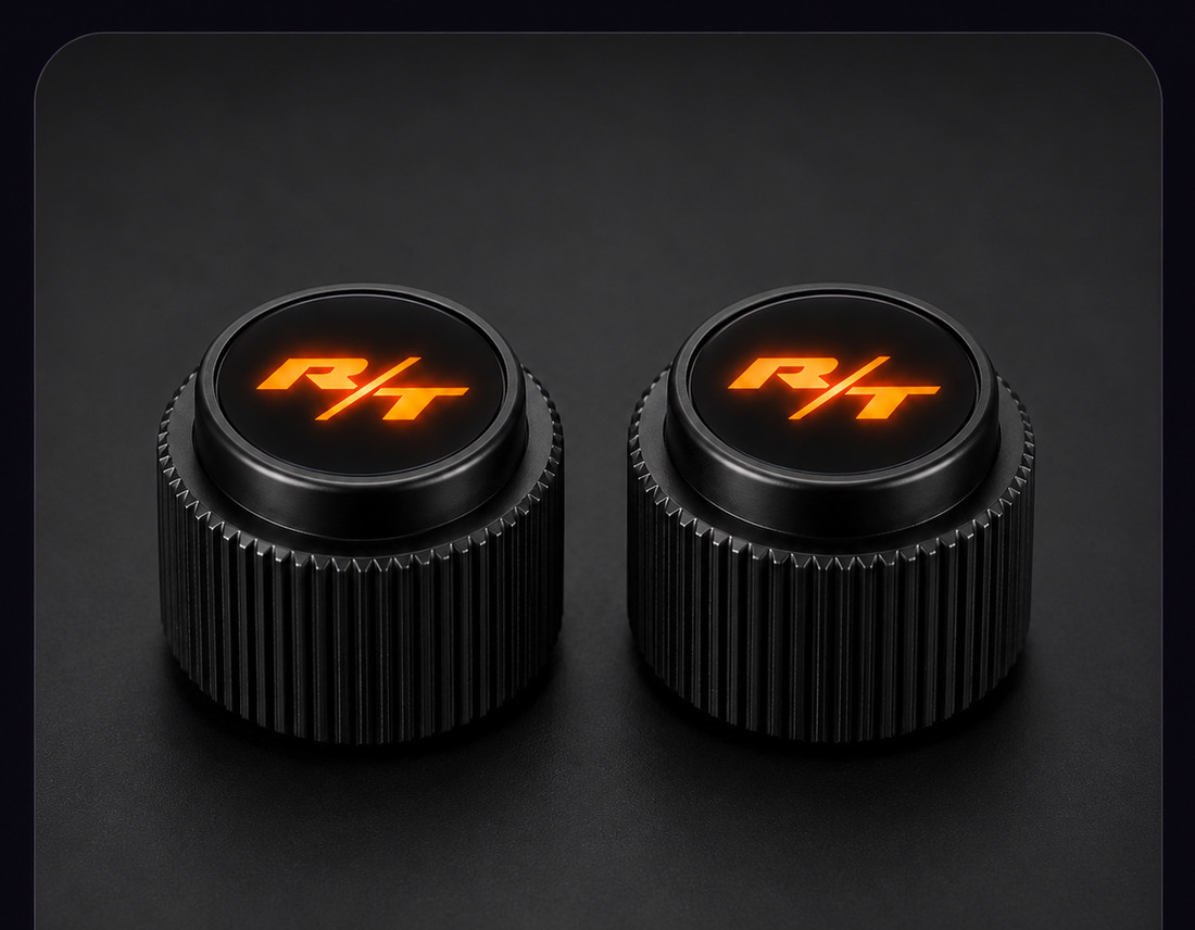 Two black Dodge Charger radio knobs with orange LED R/T lenses