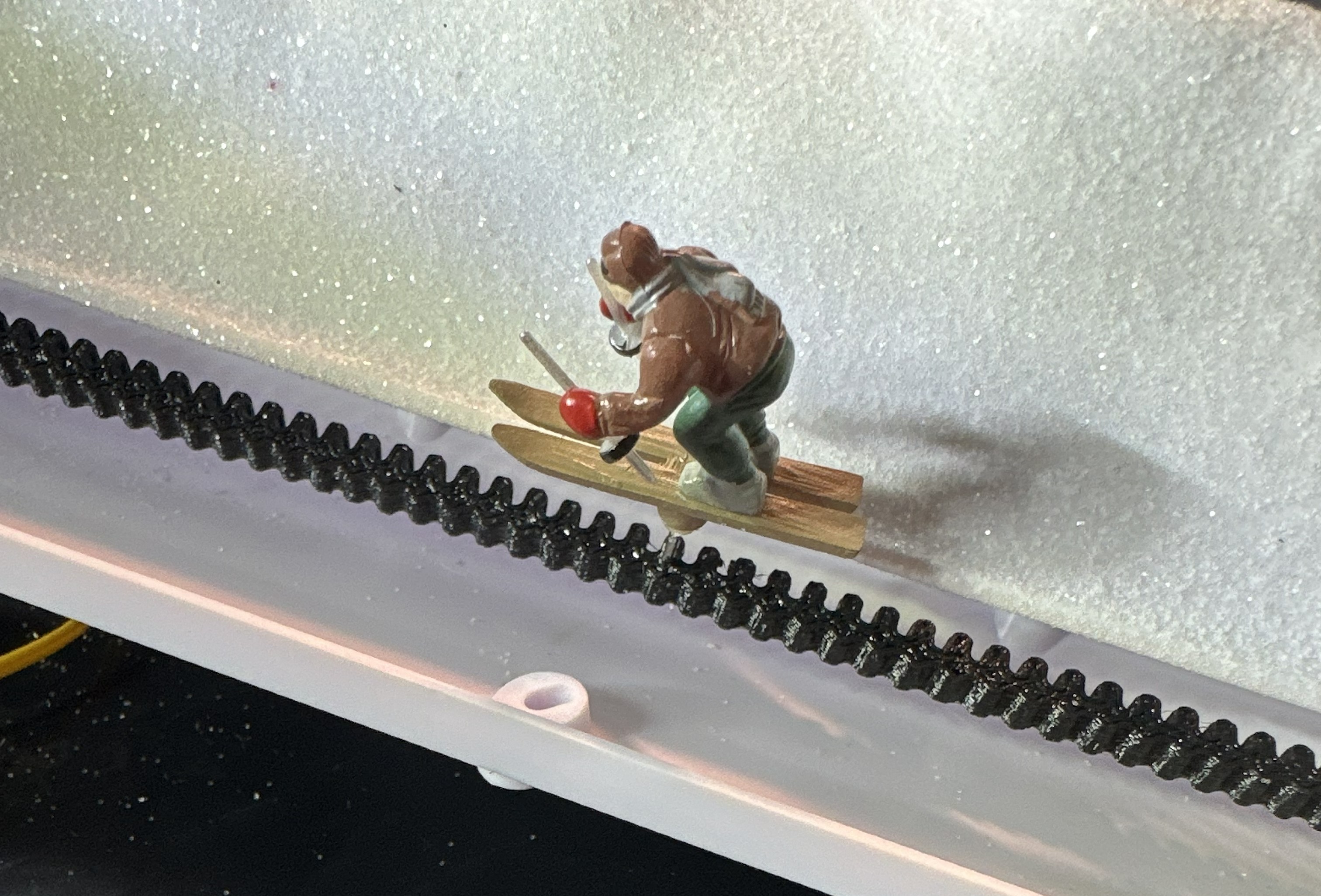 Skier figurine on custom 3D printed belt drive system